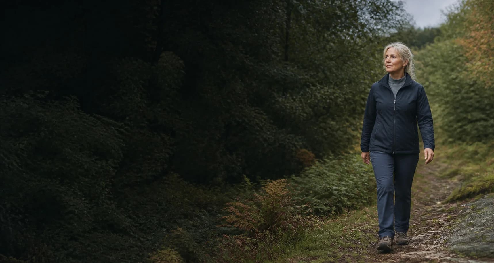 Active woman walking confidently on a woodland trail